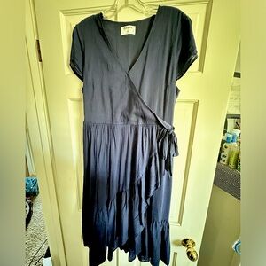 Navy blue midi length wrap dress with ruffle detail